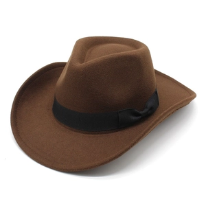 Detailed texture of brown wool felt cowboy hat featuring a black bow ribbon band