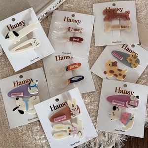 Detail of cute animal hair clips with bunny and puppy motifs on display cards