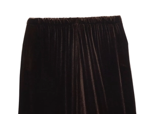 Detail view of the elastic waistband on soft dark velvet trousers for women