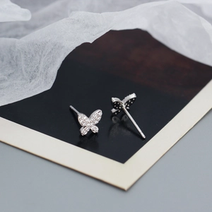 Detail shot of silver butterfly stud earrings with sparkling pave-set cubic zirconia stones