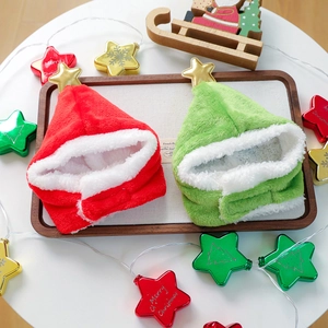 Detail of soft plush pet Christmas hats in red and green with golden star toppers