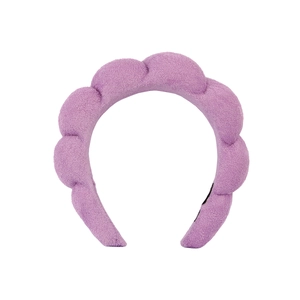 Close-up of purple towel fabric texture and sponge padding on thick headband