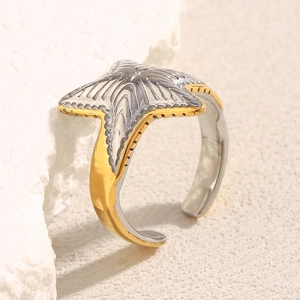 Detail of starfish ring with dual-tone gold and silver finish on textured stone