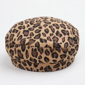 Detail of leopard print military cap showing khaki twill fabric texture and stitching