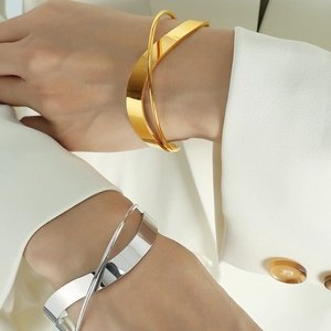 Minimalist double-layered crisscross open cuff bracelet in polished gold and silver finishes