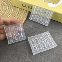 Macro view of 3D silicone nail molds featuring intricate bow and heart relief designs