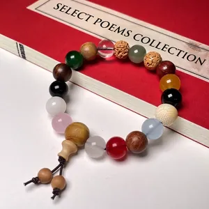 Close-up of colorful multi-material bodhi seed bracelet with red ancient book background