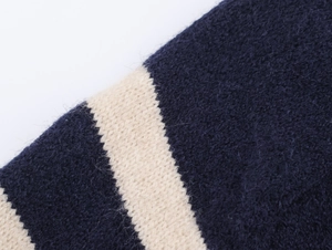 Close-up of navy and cream striped knit sweater showing soft mohair texture and stitches