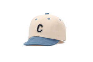 Detail of toddler baseball cap featuring contrast brim and navy blue letter C embroidery