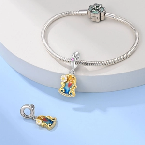 Detail of iris sunflower bell charm on silver snake chain bracelet with floral clasp