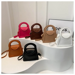 Six colors of minimalist crossbody bags with round handles and trapezoid design