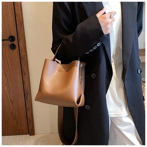 Brown leather bucket bag styled with a professional suit for an elegant office look
