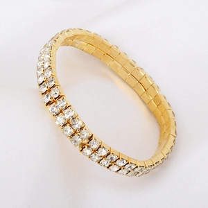 Detailed view of a two-row gold-plated tennis bracelet with sparkling cubic zirconia stones