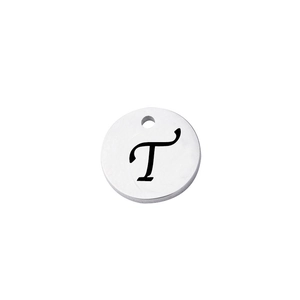Macro detail of round stainless steel pendant with engraved letter T and mirror finish