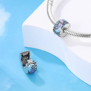 Blue and purple enamel feather charm on a silver snake chain bracelet for women