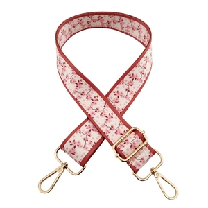 Close-up of wide floral replacement strap for handbags with gold metal lobster hooks
