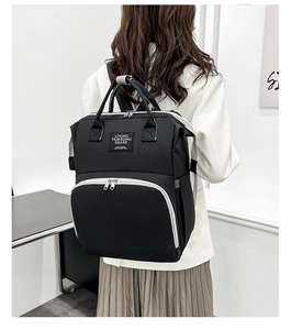 Detailed back view of a durable black Oxford fabric mommy backpack with gray handles