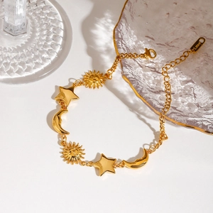 18K gold plated stainless steel bracelet with celestial sun, moon, and star charms