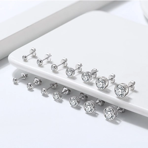 Macro view of S925 sterling silver stud earrings in various sizes on white display