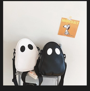 Detail of cute ghost PU leather crossbody bags in black and white with wide straps