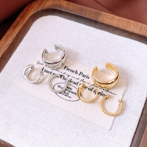 Detailed view of mixed 18k gold and silver plated non-pierced ear cuff jewelry