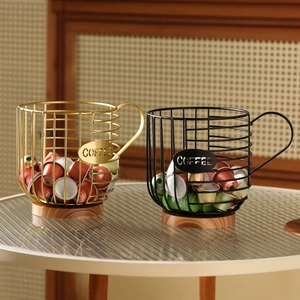 Cup-shaped metal coffee capsule wire basket with wooden base in black and gold finish