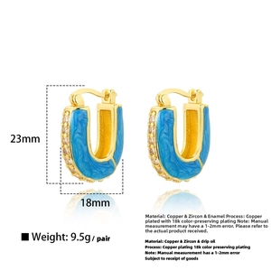 Detailed view of U-shaped gold earrings with blue enamel and white zircon stones