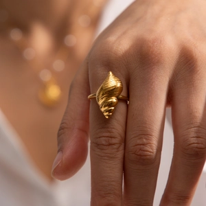 Elegant gold-plated stainless steel shell ring with realistic ocean wave texture