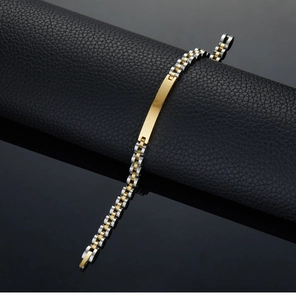 Macro view of two-tone stainless steel link bracelet with blank metal ID plaque