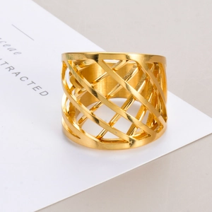 Detailed macro shot of a wide gold stainless steel ring with a modern hollow lattice design