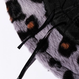Leopard print faux fur bucket hat with black ribbon drawstring and plush texture