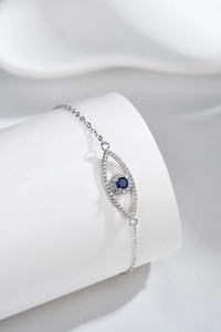 Macro shot of S925 sterling silver evil eye bracelet with blue zircon on white stand
