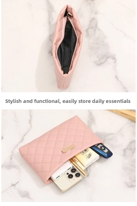 Detail view of pink quilted handbag with gold zipper and black inner lining capacity