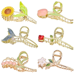 Set of six gold metal hair claw clips featuring tulip, rose, and sunflower designs