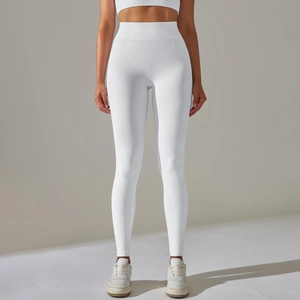 Detail of white high-waisted seamless yoga leggings with ribbed tummy control waistband