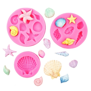 Detail view of pink silicone ocean theme molds with seashell and starfish resin shapes