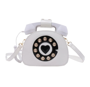 Detail of creative vintage telephone shoulder bag featuring dial pad and heart motif