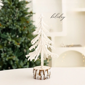 Mini white flocked Christmas tree with natural wood base for festive desktop decoration