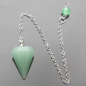 Macro shot of a green hexagonal crystal pendulum with a silver chain and matching bead