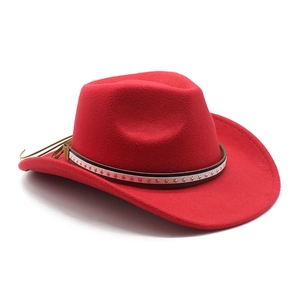 Detail of red wool felt cowboy hat featuring star studs and thin brown leather belt band