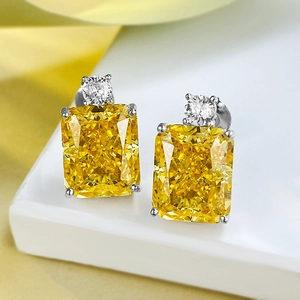 Macro view of luxury square yellow gemstone earrings with sparkling white diamonds