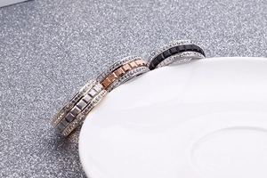 Detailed view of three-piece rose gold, silver, and black stainless steel zircon rings