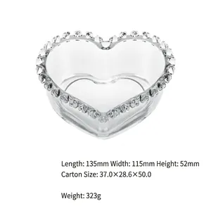 Detailed view of a transparent heart-shaped glass bowl with beaded rim 135x115x52mm size