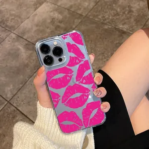 Close-up of pink lip print pattern on clear acrylic iPhone case held by hand