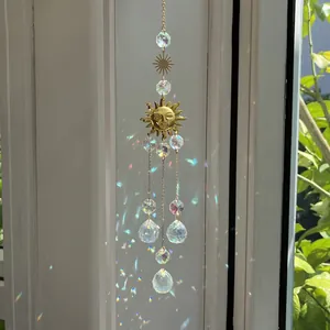 Golden suncatcher with crystal pendants and smiling sun emblem for garden decoration