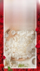 Macro detail of white non-woven artificial rose petals on a wooden tray for wedding decor