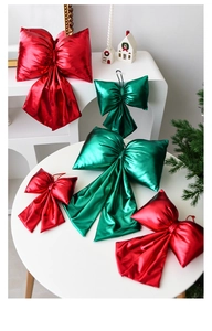 Detailed view of metallic red and green Christmas bows in various sizes for festive decor