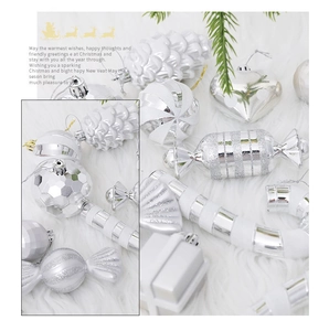 Detail of silver and white heart and candy shaped Christmas ornaments on a plush surface