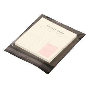 Clear OPP self-adhesive packaging bag for a weekly planner notepad in gray mailing envelope