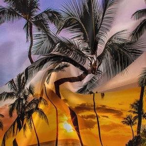 Détail du tissu en mousseline légère avec imprimé tropical de coucher de soleil